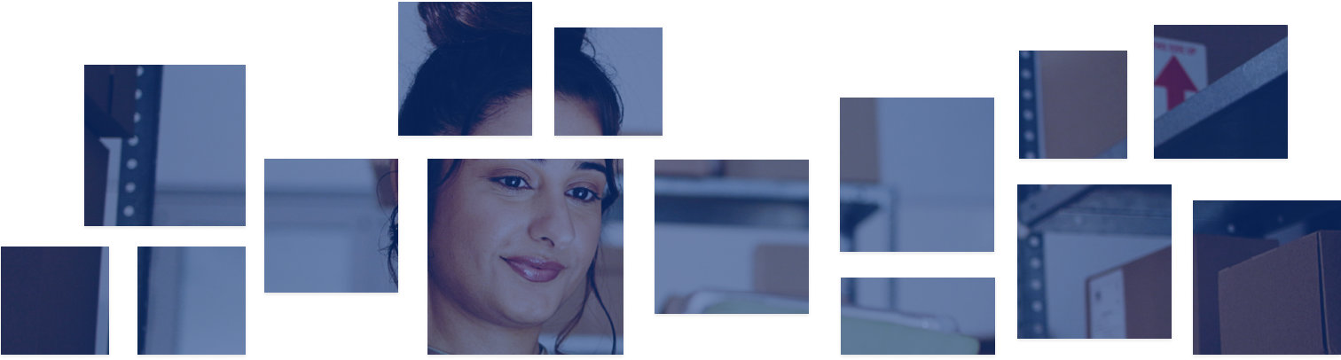 A woman looks down at a tablet in an inventory stock room.